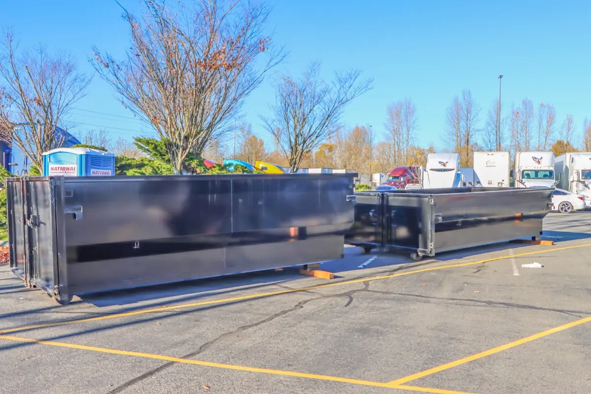 Professional dumpster rental service with roll-off container on residential driveway in Haysville